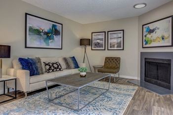 a living room with a couch coffee table and fireplace